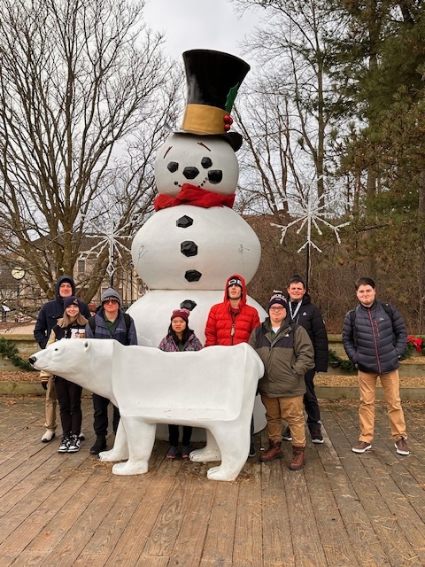 Project search students standing outside by a snowman and polar bear