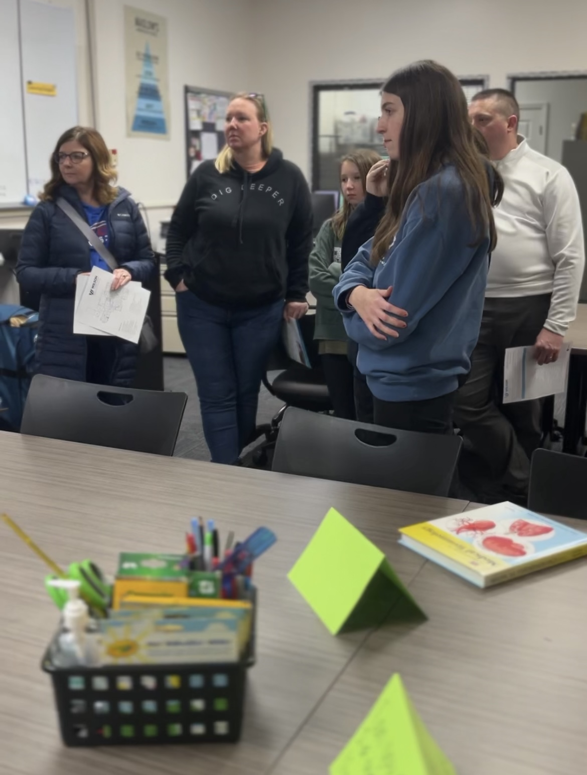 families listening to instructor tell them about the program